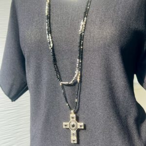 Schwarze Perlen Kette Layering mit Kreuzahänger auf schwarzen Stoff